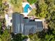 Aerial view of a luxury home with a pool and outdoor dining surrounded by lush greenery at 840 Dyson Dr, Winter Springs, FL 32708