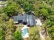 Aerial view of an expansive home nestled within a lush, green, tree-filled landscape and a private pool at 840 Dyson Dr, Winter Springs, FL 32708