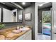 Bathroom featuring granite countertop, white sink and a door that leads to the pool at 840 Dyson Dr, Winter Springs, FL 32708