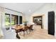 Bright dining room with large windows, wood floors, and a modern light fixture at 840 Dyson Dr, Winter Springs, FL 32708