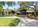 Charming exterior of a stone and wood home featuring a well-manicured lawn and inviting driveway at 840 Dyson Dr, Winter Springs, FL 32708
