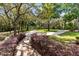 Manicured grounds with mature trees, garden bed, stone pathways and lighting at 840 Dyson Dr, Winter Springs, FL 32708