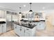 Bright kitchen with stainless steel appliances and a granite island with cooktop at 840 Dyson Dr, Winter Springs, FL 32708