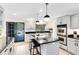 Updated kitchen features stainless steel appliances, black granite countertops, and an island with bar seating at 840 Dyson Dr, Winter Springs, FL 32708