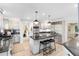 Bright kitchen boasts stainless steel appliances, a granite island, and stylish pendant lighting at 840 Dyson Dr, Winter Springs, FL 32708