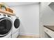Modern laundry room featuring front loading washer and dryer plus cabinets for storage at 840 Dyson Dr, Winter Springs, FL 32708