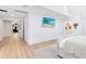 Bright main bedroom with beach view TV, featuring hardwood floors and neutral decor at 840 Dyson Dr, Winter Springs, FL 32708