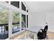 Bright office with a gray table, exterior access, and a view of the backyard at 840 Dyson Dr, Winter Springs, FL 32708