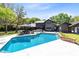 Enjoy this home's backyard oasis with a large pool and outdoor dining under the covered patio at 840 Dyson Dr, Winter Springs, FL 32708