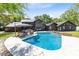Backyard view of a private pool, outdoor seating area, and well-maintained landscaping at 840 Dyson Dr, Winter Springs, FL 32708