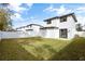 Large backyard with a well-maintained lawn and a modern, white-fenced home at 1000 Farmstead St, Eustis, FL 32736