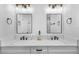 Modern bathroom with dual sinks, quartz countertops, decorative mirrors, and matte black fixtures at 1000 Farmstead St, Eustis, FL 32736