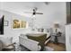 Comfortable bedroom featuring a queen bed, ceiling fan, and natural light from the window at 1000 Farmstead St, Eustis, FL 32736