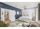 The main bedroom boasts designer wallpaper, a ceiling fan and access to the kitchen at 1000 Farmstead St, Eustis, FL 32736