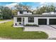 Charming two-story home with a paved driveway, well-manicured lawn and a two car garage at 1000 Farmstead St, Eustis, FL 32736