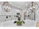 Bright modern kitchen with stainless steel appliances, quartz countertops, white cabinets, and hardwood floors at 1000 Farmstead St, Eustis, FL 32736