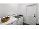 Functional laundry room with modern washer and dryer, plus storage basket at 1000 Farmstead St, Eustis, FL 32736