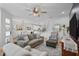 Open concept living room boasts hardwood floors and access to dining room and kitchen at 1000 Farmstead St, Eustis, FL 32736