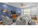 Comfortable living room area with blue accent wall, recessed lighting and a ceiling fan at 1000 Farmstead St, Eustis, FL 32736