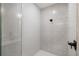 Modern shower with glass enclosure, white subway tile, rain shower head, and matte black fixtures at 1000 Farmstead St, Eustis, FL 32736