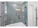 Modern shower with glass door, gray tile, and updated fixtures in bathroom at 1000 Farmstead St, Eustis, FL 32736