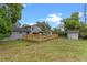 Back exterior view of home with deck, pool, patio, fenced yard, and shed at 1010 Chokecherry Dr, Winter Springs, FL 32708