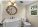 Half bathroom featuring round mirror and white vanity sink at 1010 Chokecherry Dr, Winter Springs, FL 32708