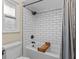 Bathroom with white subway tile, black hardware, decorative shower curtain, and patterned floor at 1010 Chokecherry Dr, Winter Springs, FL 32708