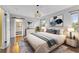 Bright bedroom with wood floors, stylish pendant lighting, and a view into the ensuite bathroom at 1010 Chokecherry Dr, Winter Springs, FL 32708