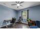 A comfortable room features blue walls, ceiling fan and stylish furnishings at 1010 Chokecherry Dr, Winter Springs, FL 32708