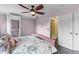 Bedroom with pink walls, a ceiling fan, and a Stiltz lift for easy access to other floors at 1010 Chokecherry Dr, Winter Springs, FL 32708