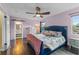 Bedroom with hardwood floors, lavender walls, and an ensuite with a visible bathroom at 1010 Chokecherry Dr, Winter Springs, FL 32708