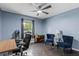 A comfortable room features blue walls, ceiling fan and stylish furnishings at 1010 Chokecherry Dr, Winter Springs, FL 32708