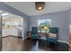Bright dining area with dark wood floors, modern chairs, and a seamless view to a modern white kitchen at 1010 Chokecherry Dr, Winter Springs, FL 32708