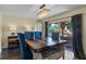 Bright dining room featuring rustic table, contemporary chandelier, and sliding door to backyard patio at 1010 Chokecherry Dr, Winter Springs, FL 32708