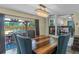Dining room with dark wood floors and sliding glass doors to the deck and pool area at 1010 Chokecherry Dr, Winter Springs, FL 32708
