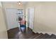Inviting entryway with dark hardwood floors, steps, front door and adjacent closet space at 1010 Chokecherry Dr, Winter Springs, FL 32708