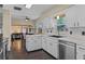 Bright kitchen with white cabinets, stainless steel appliances, and a window overlooking the backyard at 1010 Chokecherry Dr, Winter Springs, FL 32708