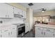 Updated kitchen boasting white cabinetry, subway tile backsplash, stainless steel appliances, and dark wood floors at 1010 Chokecherry Dr, Winter Springs, FL 32708