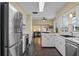 Well-lit kitchen with stainless steel appliances, white cabinets, and dark wood floors at 1010 Chokecherry Dr, Winter Springs, FL 32708