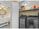 Laundry room with modern washer and dryer, plus a partial view of the bathroom at 1010 Chokecherry Dr, Winter Springs, FL 32708