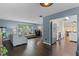 Open-concept living room flowing into a modern kitchen with dark wood floors and an abundance of light at 1010 Chokecherry Dr, Winter Springs, FL 32708