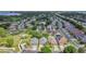 Aerial view featuring homes near a pond, mature trees, and community layout, emphasizing the neighborhood's charm and design at 10621 Golden Cypress Ct, Orlando, FL 32836