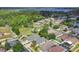 An aerial view reveals the property's lush surroundings near a lake, emphasizing its prime location and community amenities at 10621 Golden Cypress Ct, Orlando, FL 32836