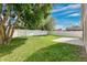 Spacious backyard with mature trees, green grass, and white privacy fence at 10621 Golden Cypress Ct, Orlando, FL 32836