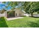Lush backyard showcasing a cozy patio, well-maintained lawn, privacy fence, and beautiful landscaping at 10621 Golden Cypress Ct, Orlando, FL 32836