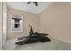 Bright bedroom with neutral carpet featuring a treadmill near the window at 10621 Golden Cypress Ct, Orlando, FL 32836