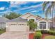 Charming single-story home with a two car garage, manicured landscaping, and brick paved driveway at 10621 Golden Cypress Ct, Orlando, FL 32836