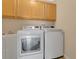 Laundry room featuring new washer and dryer, utility sink, and natural wood cabinets at 10621 Golden Cypress Ct, Orlando, FL 32836