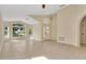 Bright living room with tiled floors and large windows providing ample natural light throughout the house at 10621 Golden Cypress Ct, Orlando, FL 32836